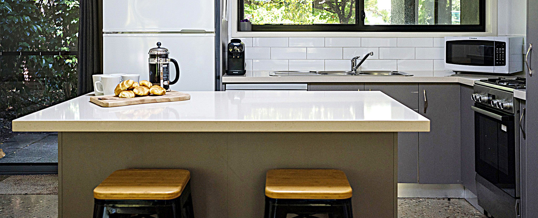 10a-New-kitchen-with-gas-cooking,-Nespresso-coffee-machine,-full-fridge-and-outlook-to-BBQ-and-back-garden