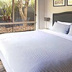 25a--Bedroom-1.--King-size-bed-looking-over-the-garden-and-pool